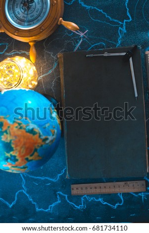 Still life globe on a black matte background with a barometer Royalty-Free Stock Photo #681734110