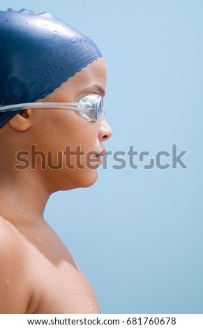 Boy in swimming cap and goggles