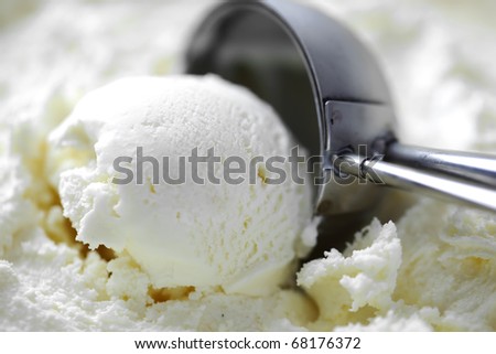 Creamy ice cream with a spoon and leaf