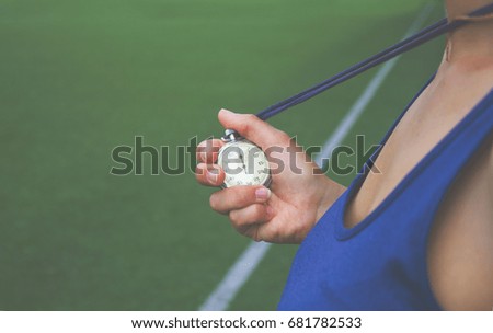 Female fitness trainer with stopwatch