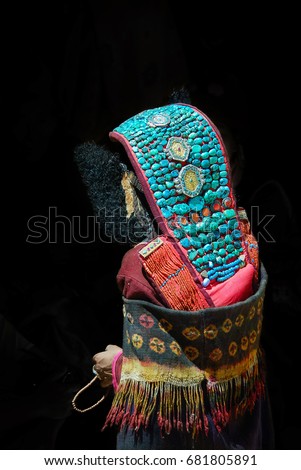 Zanskari Woman Wearing Ethnic Traditional Ladakhi Clothing of full Bejeweled and Perak (Turquoise Encrusted Hat) join the Ceremony, Zanskar Valley, Ladakh Region, Jammu and Kashmir, India. 