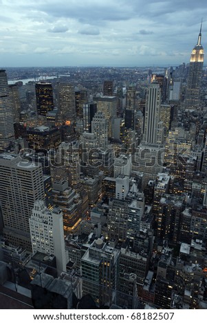 Photo of New York city as it's becomes nighttime. Empire State Building to the right.