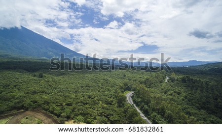 Highway between trees and volcanoes in Guatemala, Central America. 