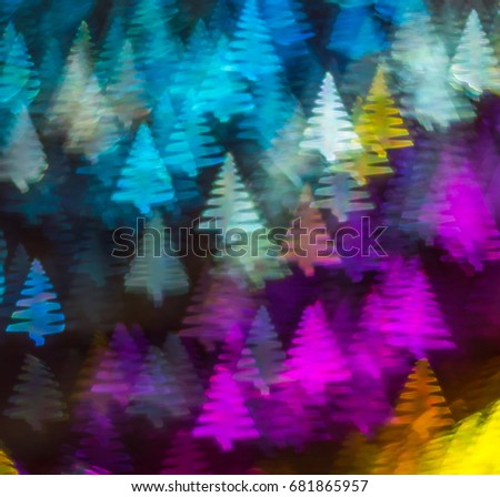 Beautiful background with different colored christmas tree , abstract background, christmas tree  shapes on black background, blurry