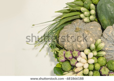 Many Asian vegetables in a basket placed on a flat surface.