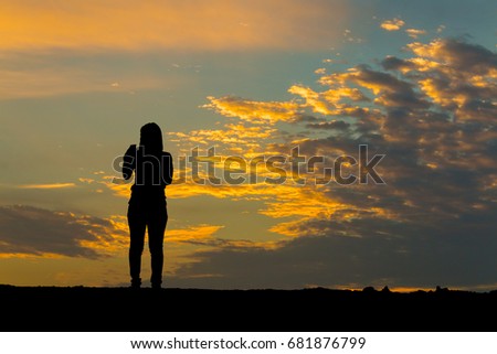 Silhouette people on sunset background