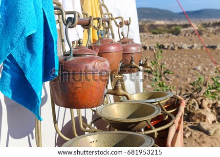 Washbasin in the desert in the form of ancient teapots