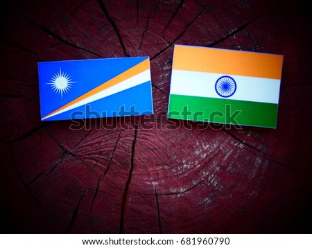 Marshall Islands flag with Indian flag on a tree stump isolated