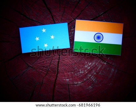 Micronesian flag with Indian flag on a tree stump isolated