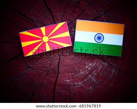 Macedonian flag with Indian flag on a tree stump isolated