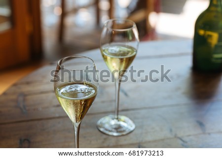 Flutes filled with sparkling Prosecco, in a restaurant in Conegliano. Prosecco is a white sparkling wine cultivated and produced in Valdobbiadene-Conegliano area. Royalty-Free Stock Photo #681973213