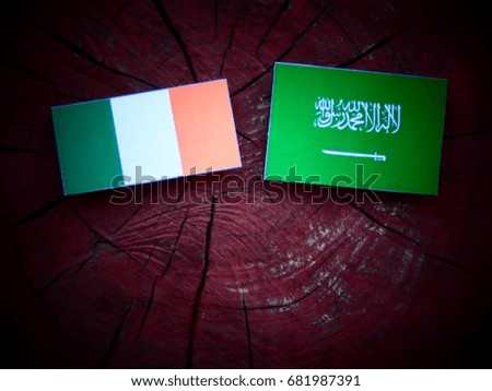 Irish flag with Saudi Arabian flag on a tree stump isolated