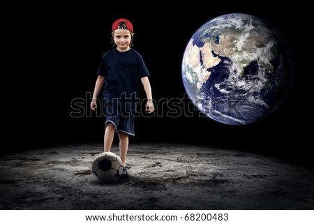 Child football player and Grunge ball on the dark background
