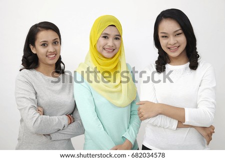 three mix racial malaysian looking at camera