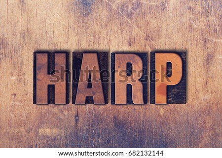 The word Harp concept and theme written in vintage wooden letterpress type on a grunge background.
