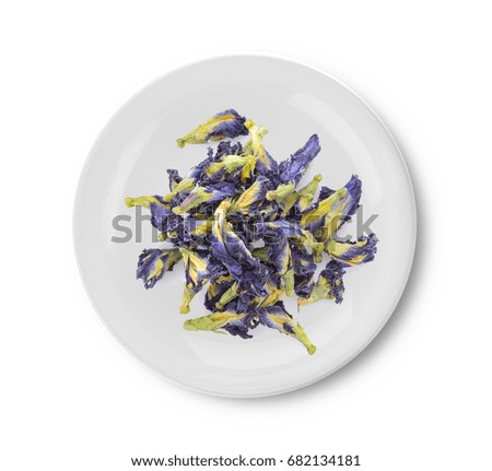 Dried pea flower in plate on white background