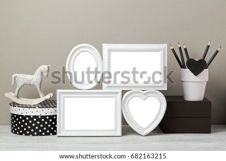 Frames mock up with rocking horse toy and pencils. Nursery or kids room interior background