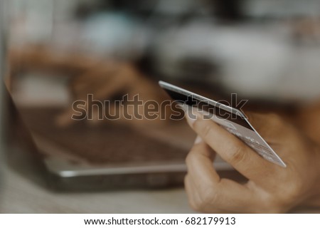 Hands holding credit card and using laptop. Online shopping / soft focus picture / Vintage concept