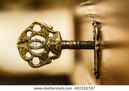 macro shot of an antique and weathered vintage key in his keyhole Royalty-Free Stock Photo #682182187