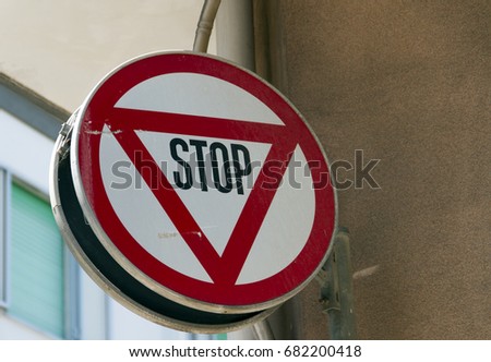 Mixed signals - Stop and Yield traffic sign all in one in Ostuni Italy.  
