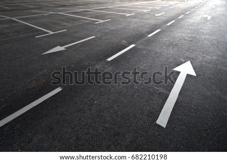 Traffic signs on the asphalt surface of the parking lot