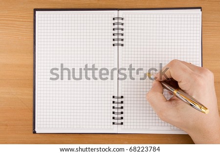 hand writing by pen on checked notebook