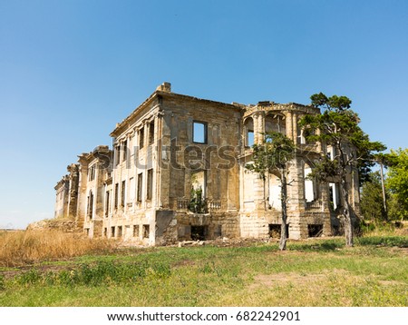 Mystical Interior, ruins of facade of an abandoned ruined building of an ancient castle 18th century. Old ruined walls, corridor with garbage and mud. Ruins Ancient historic building destroyed by war