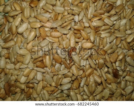 Cleaned sunflower seeds - the fruit of the sunflower Tlo. The main color, the tone on which the drawing is made; Background picture of a picture; Something that stands out for someone, something