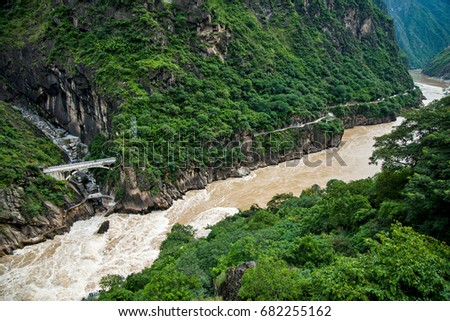 Tiger leaping gorge is a gorge formed by river Jinsha, the upper reach of the Yangtse river. It is a part of famous World Heritage Site Three Parallel rivers. Royalty-Free Stock Photo #682255162