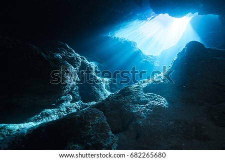 Rays of sunlight shining into the cave, underwater view