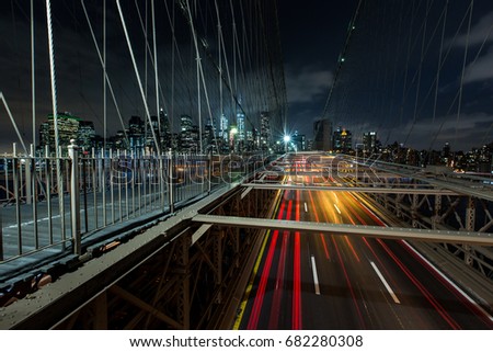 Dusk busy traffic over Brooklyn Bridge with Lower Manhattan Skyline, New York United States