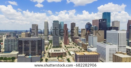 Panorama, aerial view Houston downtown against cloud blue sky with empty parking lot at weekends and background of skyscrapers/high-rises in the business district area. Architecture, travel background