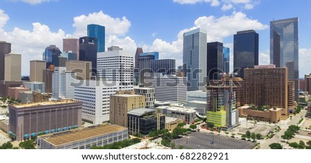 Panorama, aerial view Houston downtown against cloud blue sky with empty parking lot at weekends and background of skyscrapers/high-rises in the business district area. Architecture, travel background