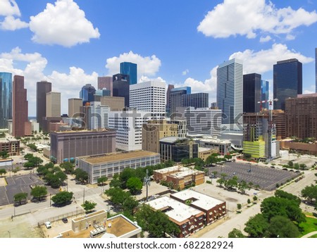 Aerial view Houston downtown against cloud blue sky with empty parking lot at weekends and background of skyscrapers/high-rises in the business district area. Architecture and travel background