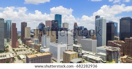 Panorama aerial view Houston downtown against cloud blue sky with empty parking lot at weekends, building/high-rises under construction and background of skyscrapers in the business district area