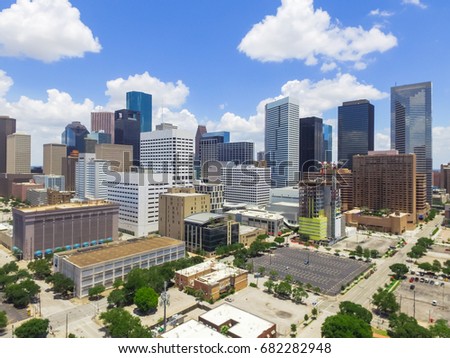 Aerial view Houston downtown against cloud blue sky with empty parking lot at weekends and background of skyscrapers/high-rises in the business district area. Architecture and travel background