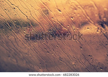 Flowing down drops of rain on windshield. Fall concept.