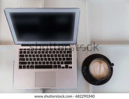 Desk with laptop and a cup of coffee, Top view