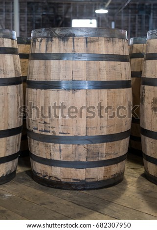 Single Bourbon Barrel in Storage of whiskey distillery Royalty-Free Stock Photo #682307950