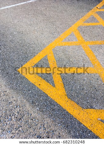 yellow no parking area on asphalt street