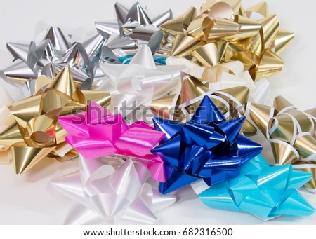 Pile of colorful gift bows on white background. Royalty-Free Stock Photo #682316500
