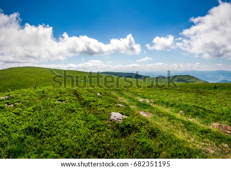 summer landscape. path through hillside meadow on the mountain ridge under the cloudy sky