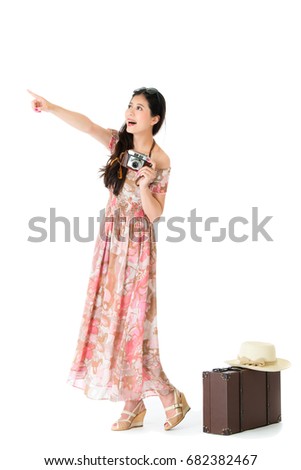 cheerful beauty woman tourist standing on white background pointing empty area.