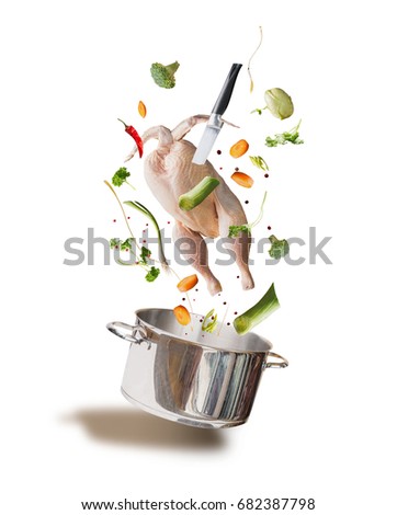 Flying raw chicken stock ,bouillon or soup ingredients with whole chicken, vegetables,seasoning, knife and cooking pot, front view, isolated on white background. Flying food concept
