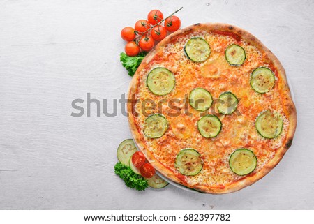 Zucchini Pizza. On a wooden background. Top view. Free space for your text.