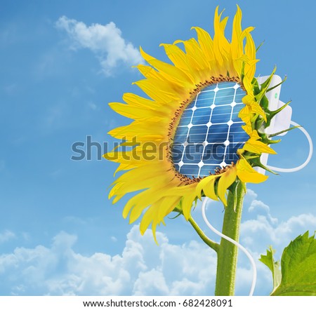 A picture of sunflower with integrated solar panel - ecology and energy saving concept