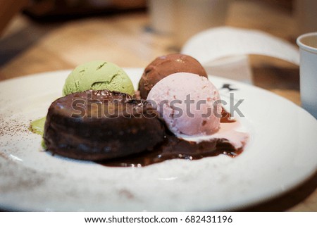 Blurred chocolate lava cake with ice cream.