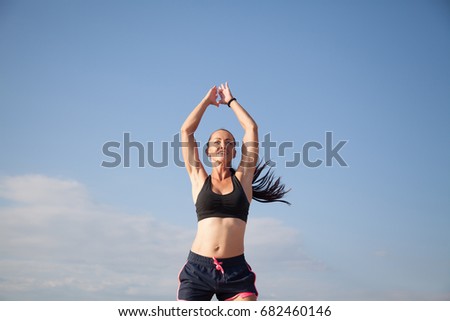 Sports girl is engaged in fitness on the beach