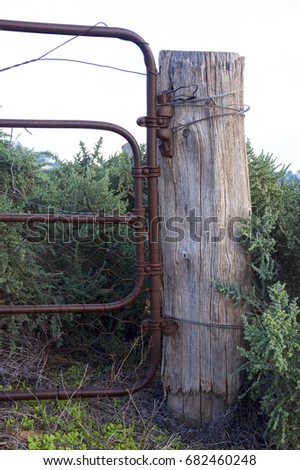 Wooden post and rusty fence in outback NSW, Australia