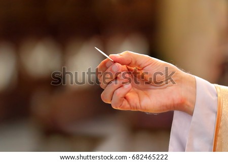 Priest gives holy communion to faithful and empty space for text

 Royalty-Free Stock Photo #682465222